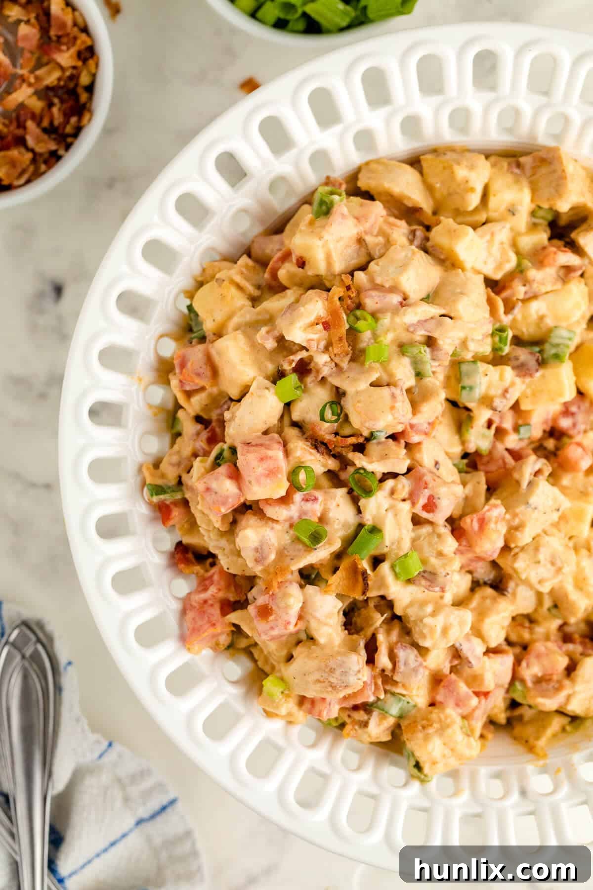Crisp BLT Chicken Salad 4 Close-up of Chicken BLT Salad ingredients mixed in a white bowl before dressing.