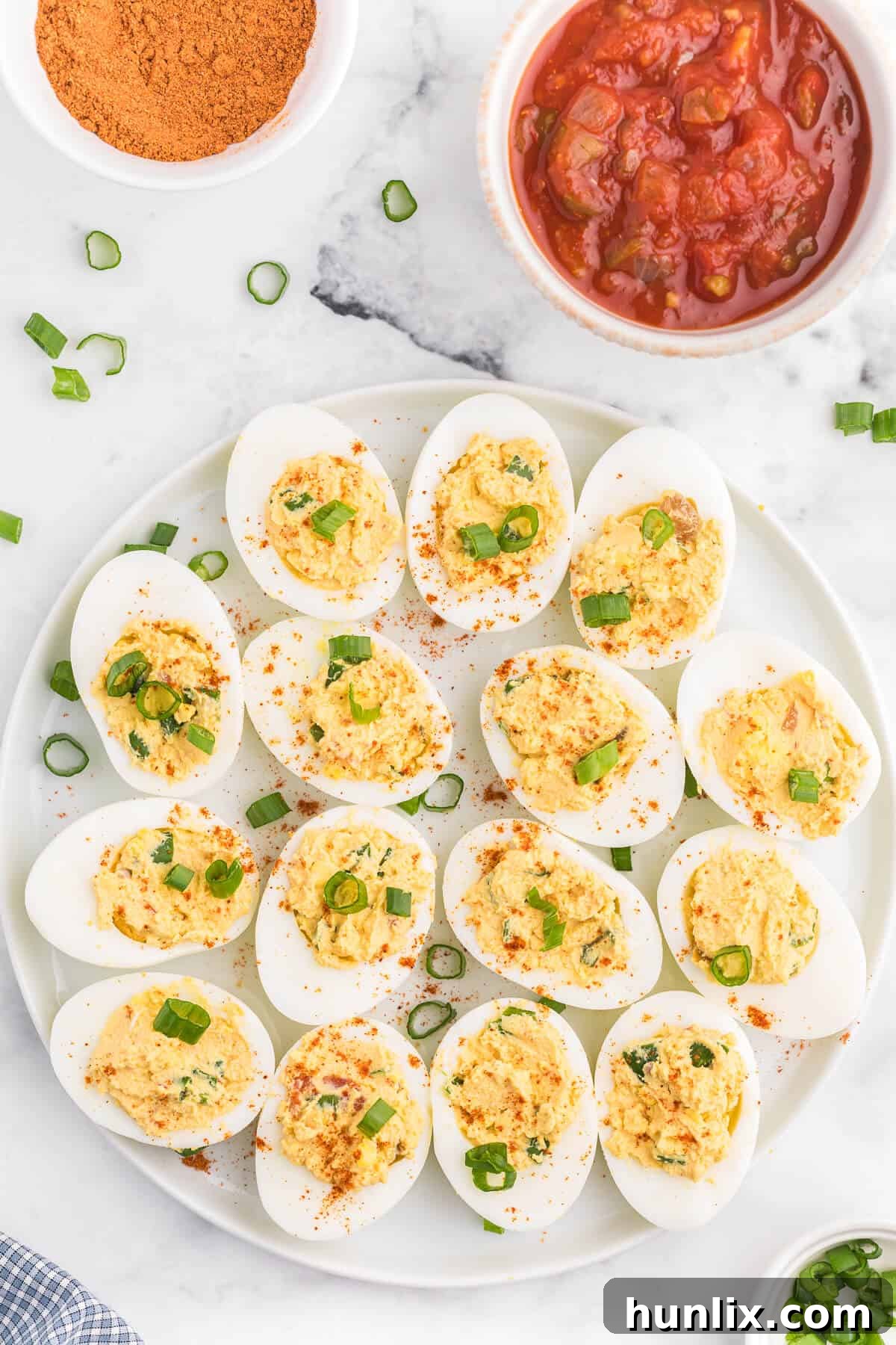 Fiesta Deviled Eggs 2 Salsa Deviled Eggs - a spicy kick to a popular appetizer recipe! This recipe is always gobbled up quickly.