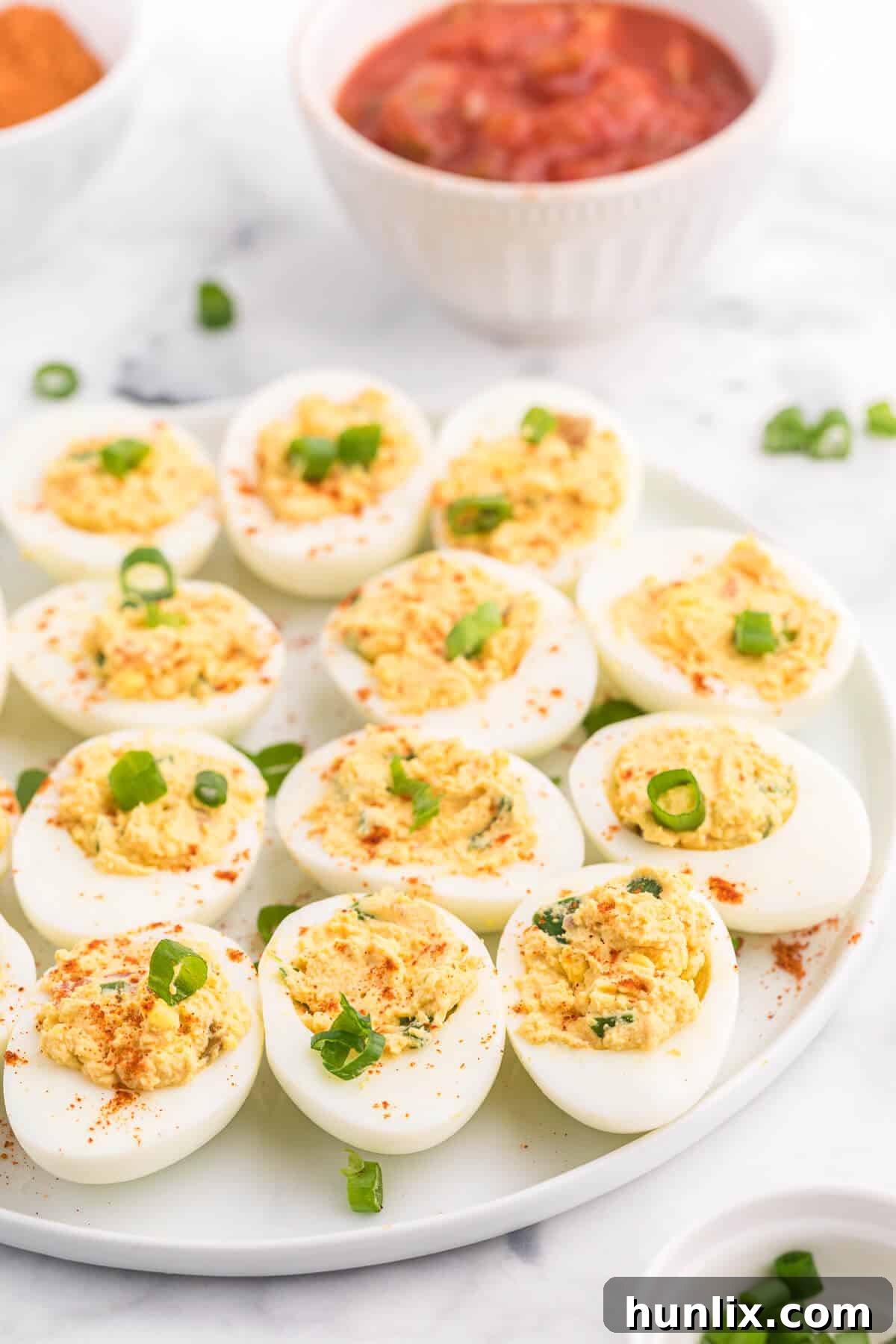 Fiesta Deviled Eggs 4 Salsa Deviled Eggs - a spicy kick to a popular appetizer recipe! This recipe is always gobbled up quickly.