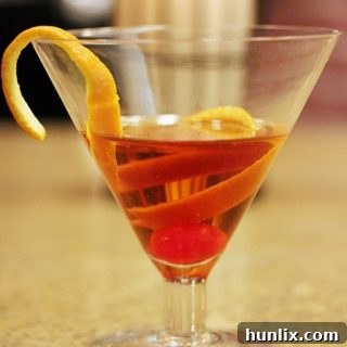 The Appleton Estate Manhattan cocktail, garnished with an orange peel and a cherry.