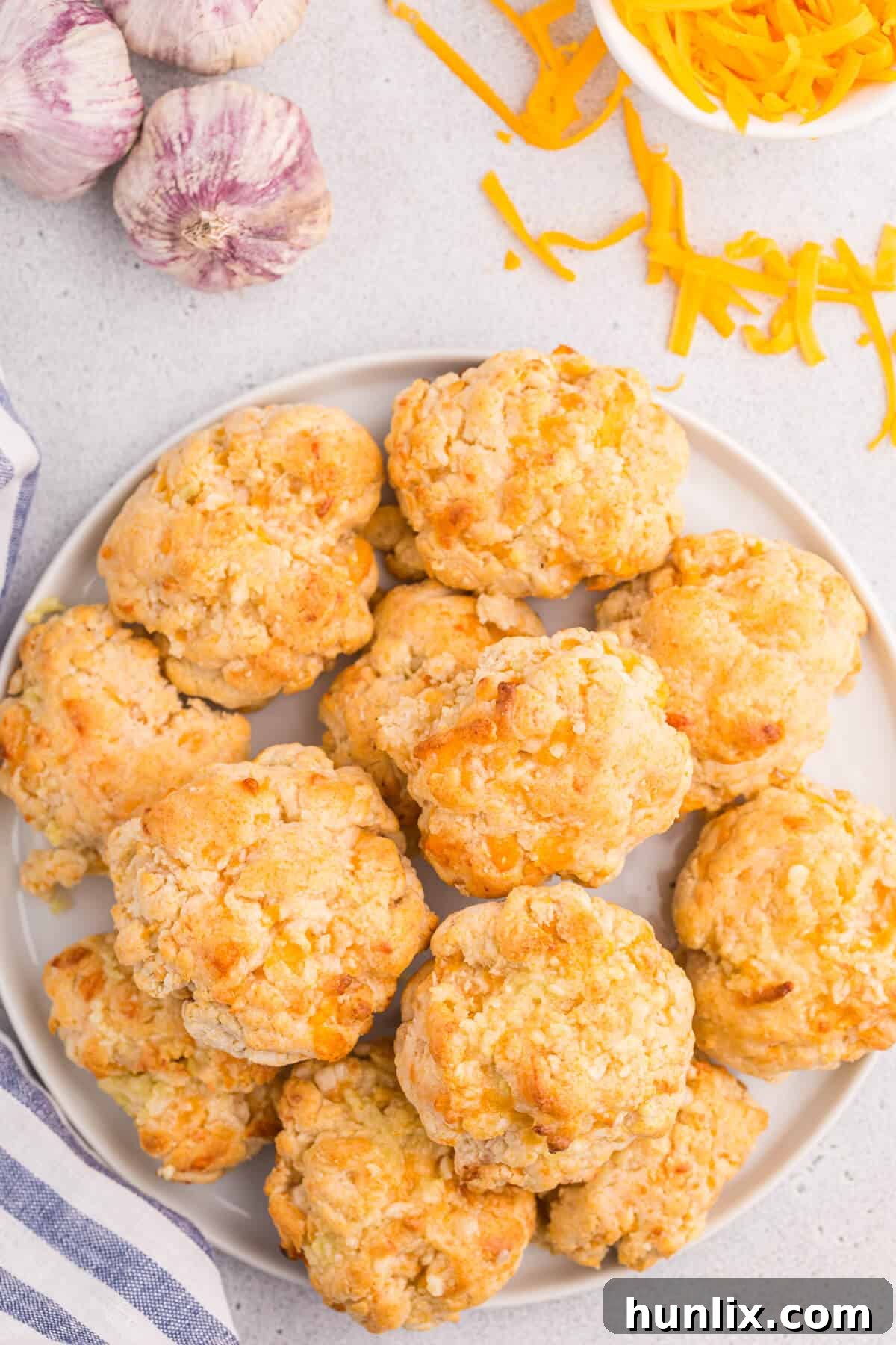 Buttery Garlic Cheese Biscuits 2 Freshly baked cheesy garlic biscuits on a white plate, ready to be served.