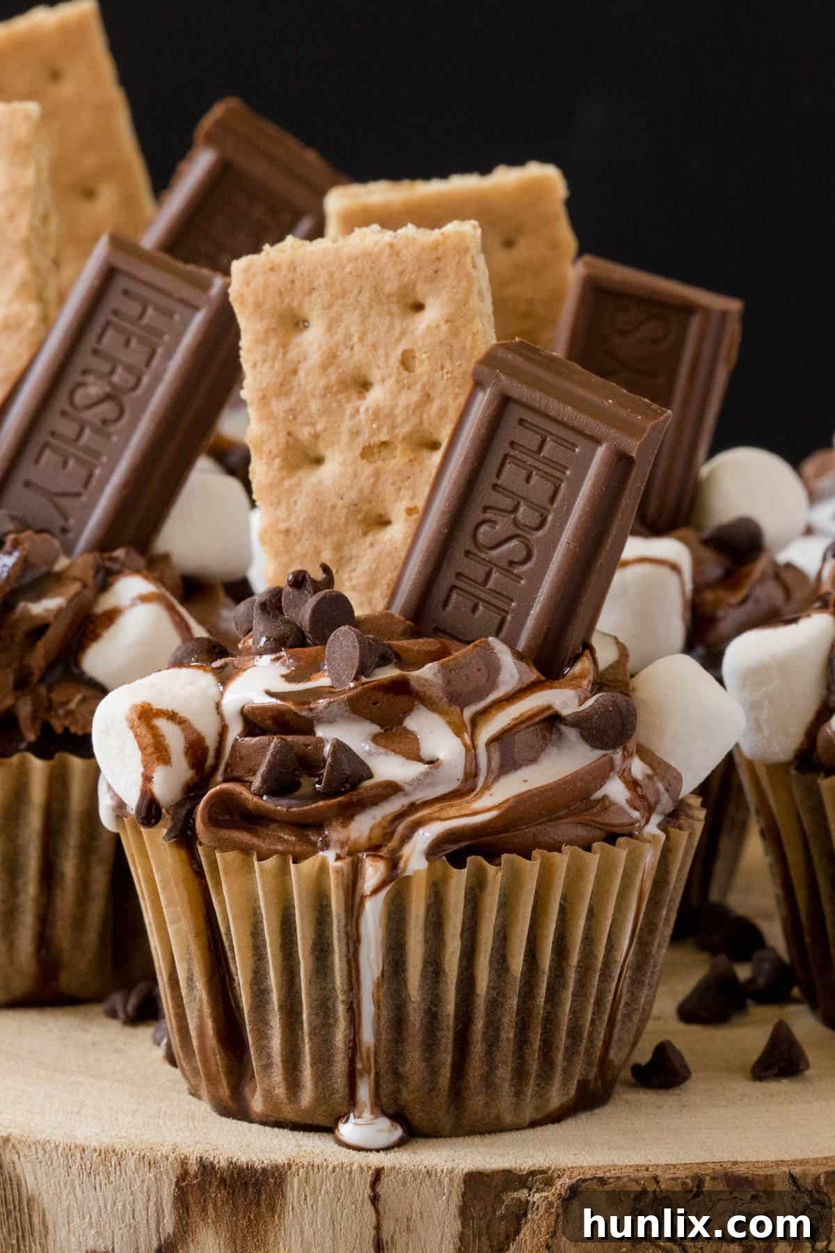 Decadent S'mores Cupcakes with toasted marshmallow frosting and chocolate drizzle