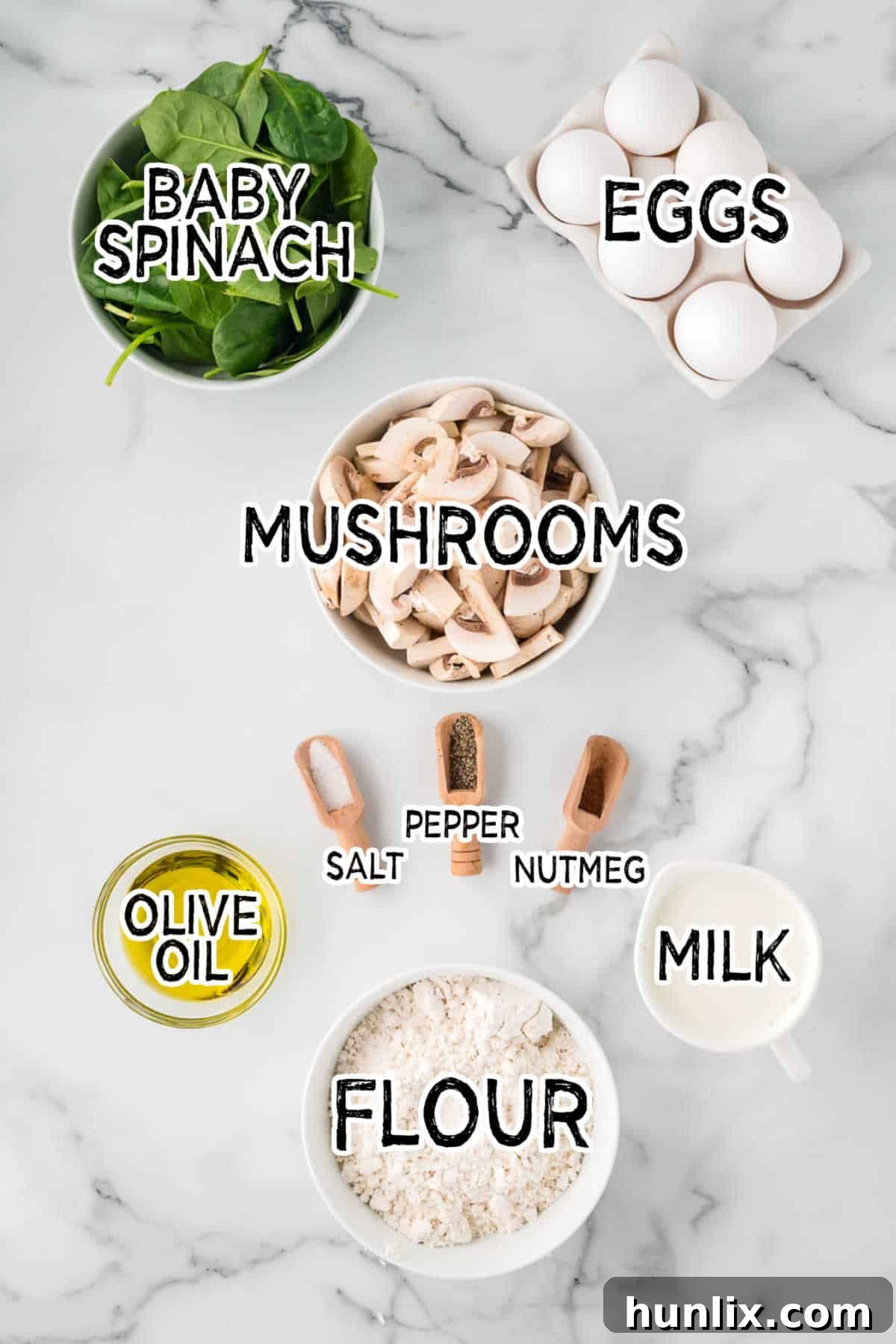 Earthy Mushroom and Fresh Spinach Quiche 3 Various quiche ingredients laid out on a clean white marble background. This includes a bowl of flour, olive oil, milk, a carton of eggs, a pile of fresh spinach, sliced mushrooms, and small bowls of salt, pepper, and nutmeg.