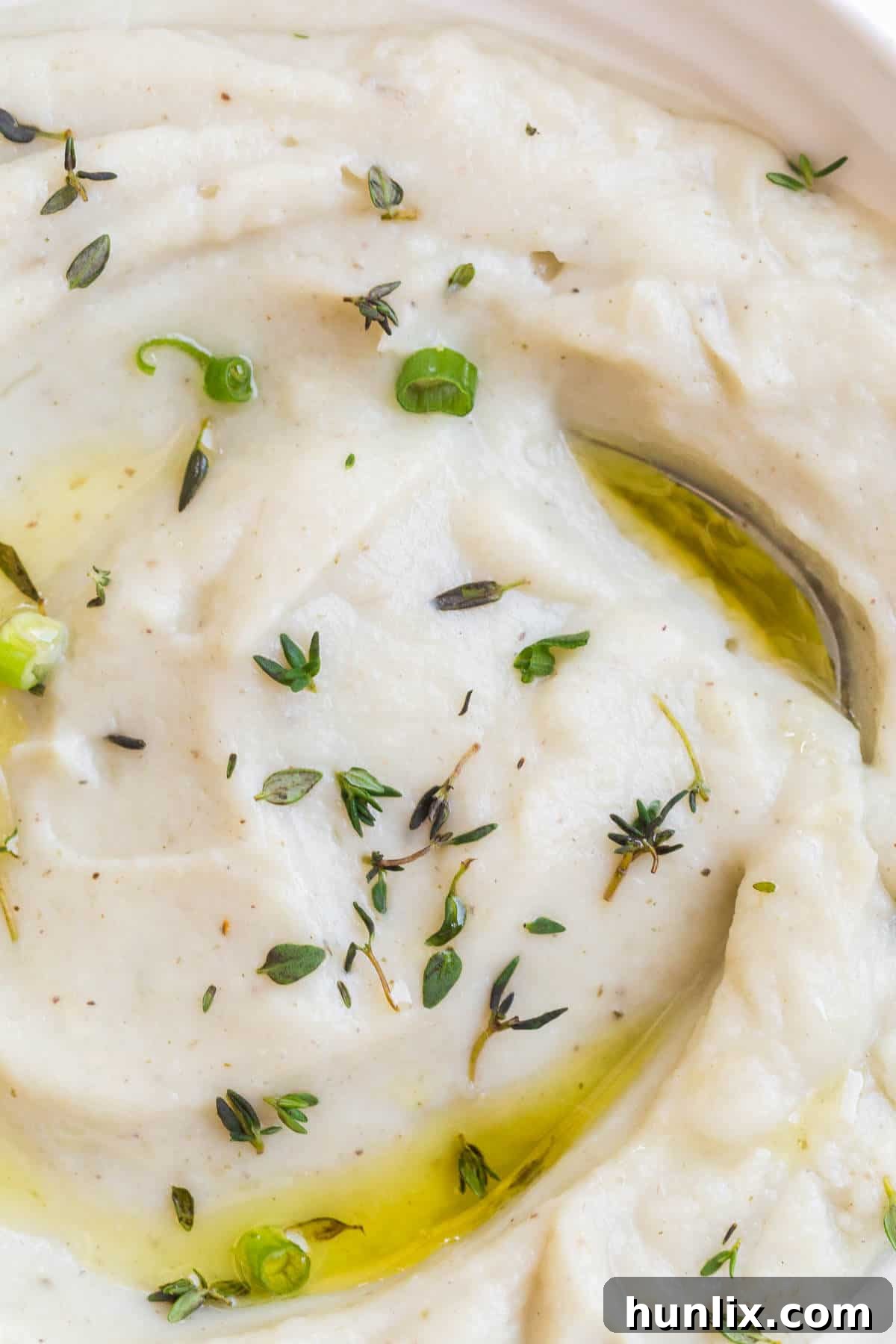 Creamy Vegan Cauliflower Mash 4 A close-up view of vegan mashed cauliflower, showcasing its smooth and inviting texture, ready to be enjoyed as a low-carb side dish.