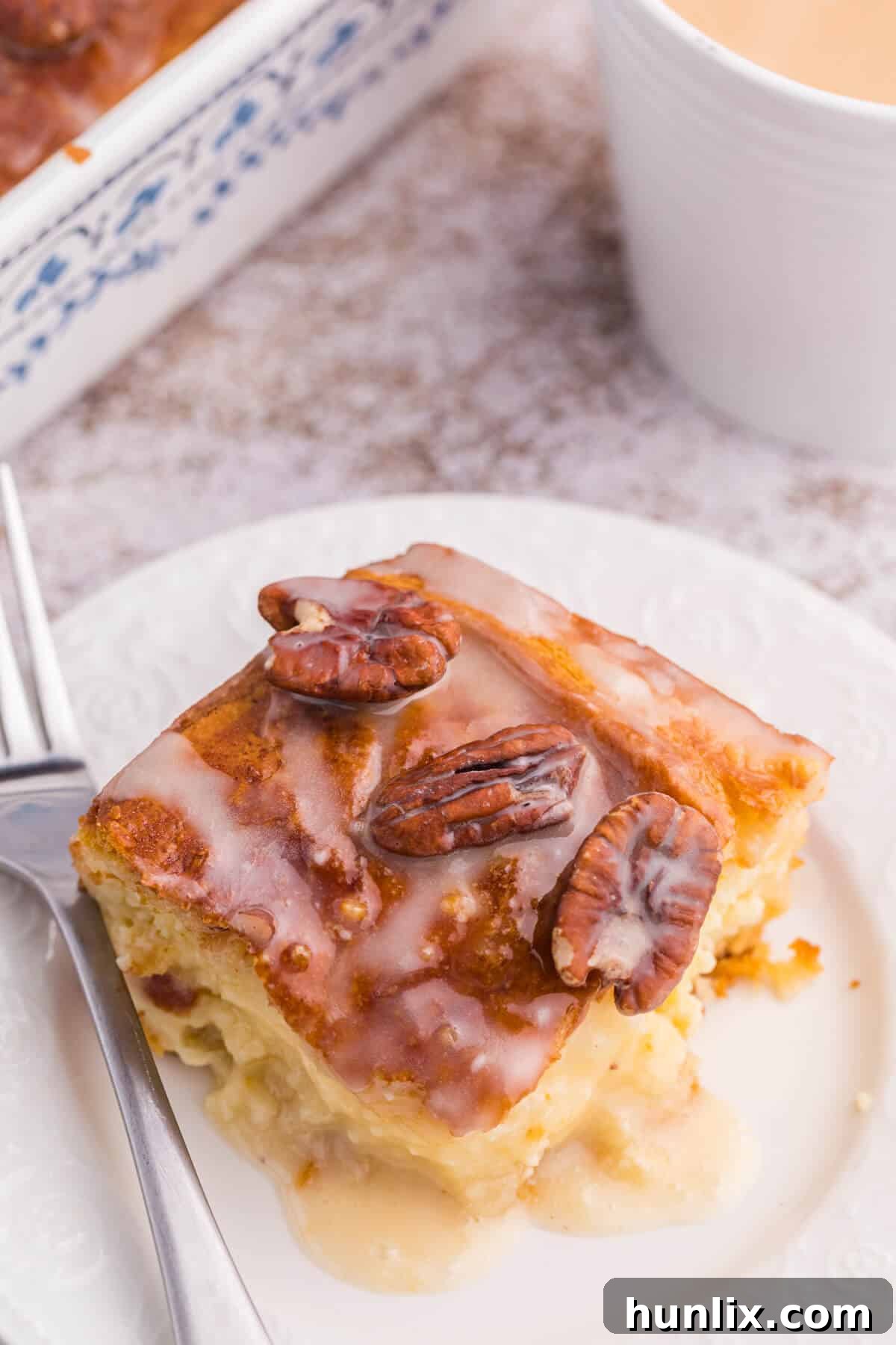 A whole maple pecan danish bake ready to be served on a plate.