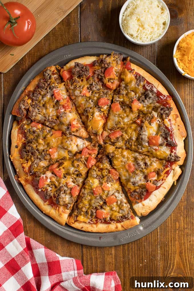 Cheeseburger pizza on a pizza pan.