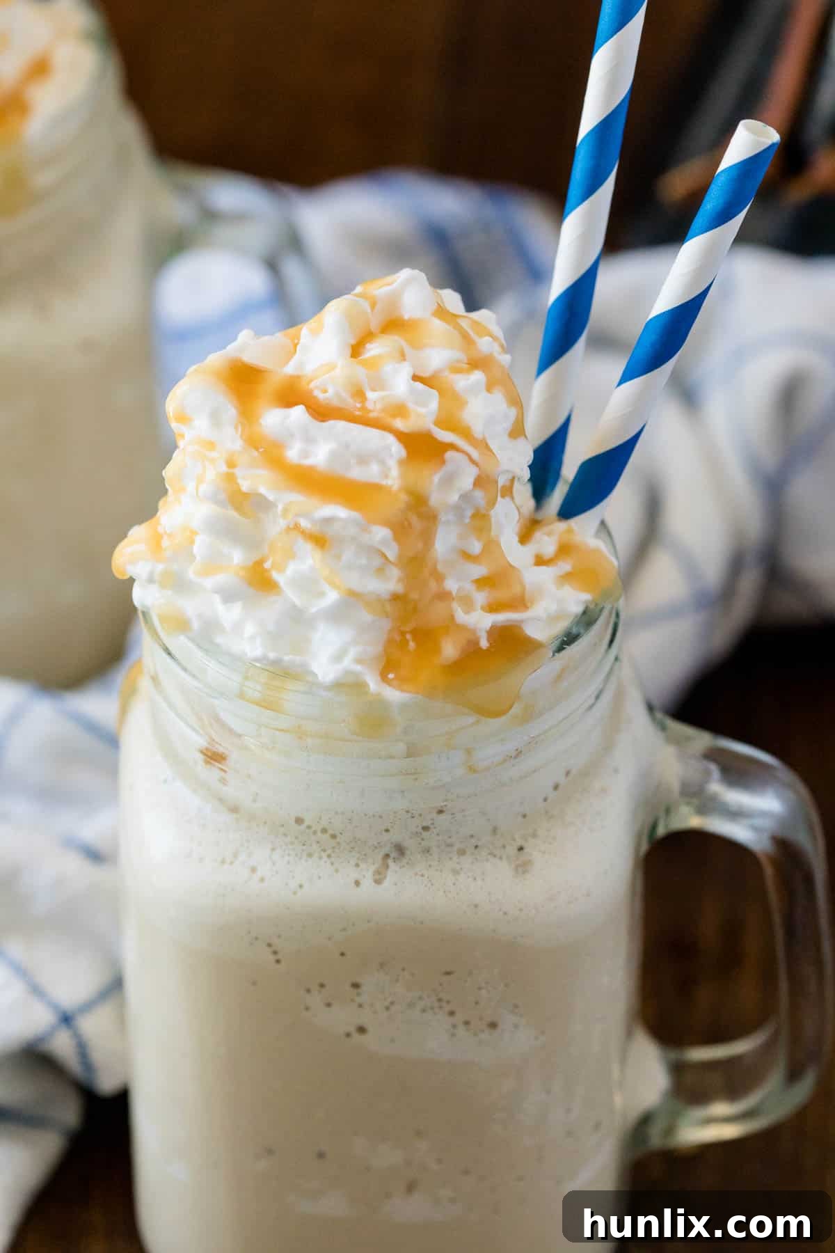 The recipe in a mug with two blue and white striped straws.
