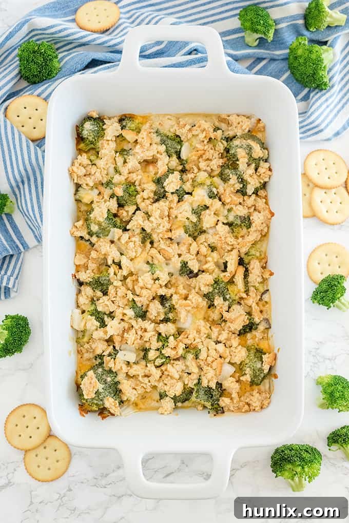 Broccoli casserole in a white caserole dish, garnished with parsley.