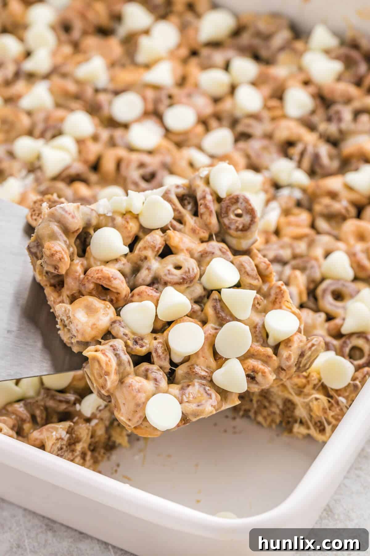 No Bake White Chocolate Peanut Butter Cheerios Squares 6 A pan filled with perfectly set White Chocolate Peanut Butter Cheerios Treats, ready to be cut into squares.