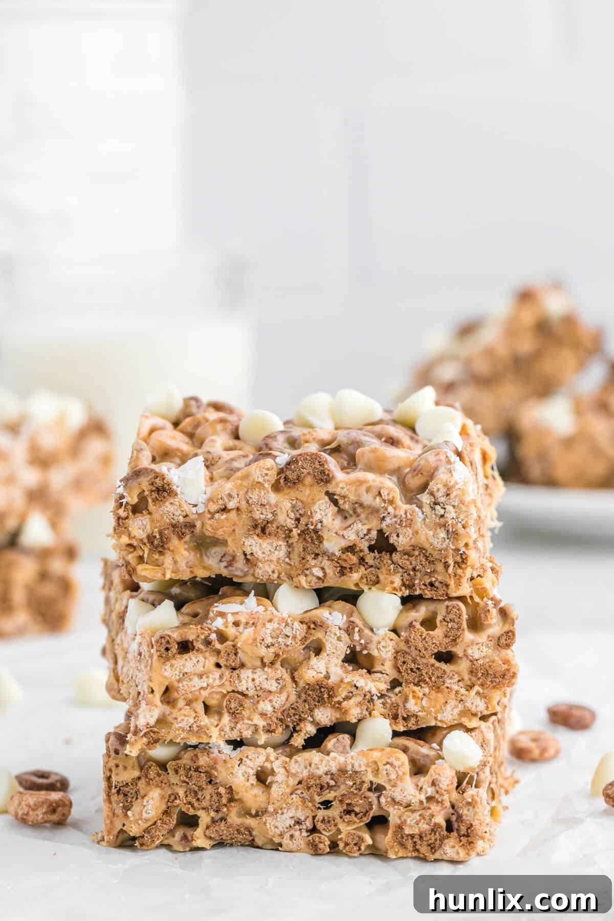 No Bake White Chocolate Peanut Butter Cheerios Squares 8 A stack of golden White Chocolate Peanut Butter Cheerios Treats, showcasing their delightful texture and readiness to be enjoyed.