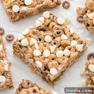 No Bake White Chocolate Peanut Butter Cheerios Squares 9 White Chocolate Peanut Butter Cheerios Treats cut into bars.