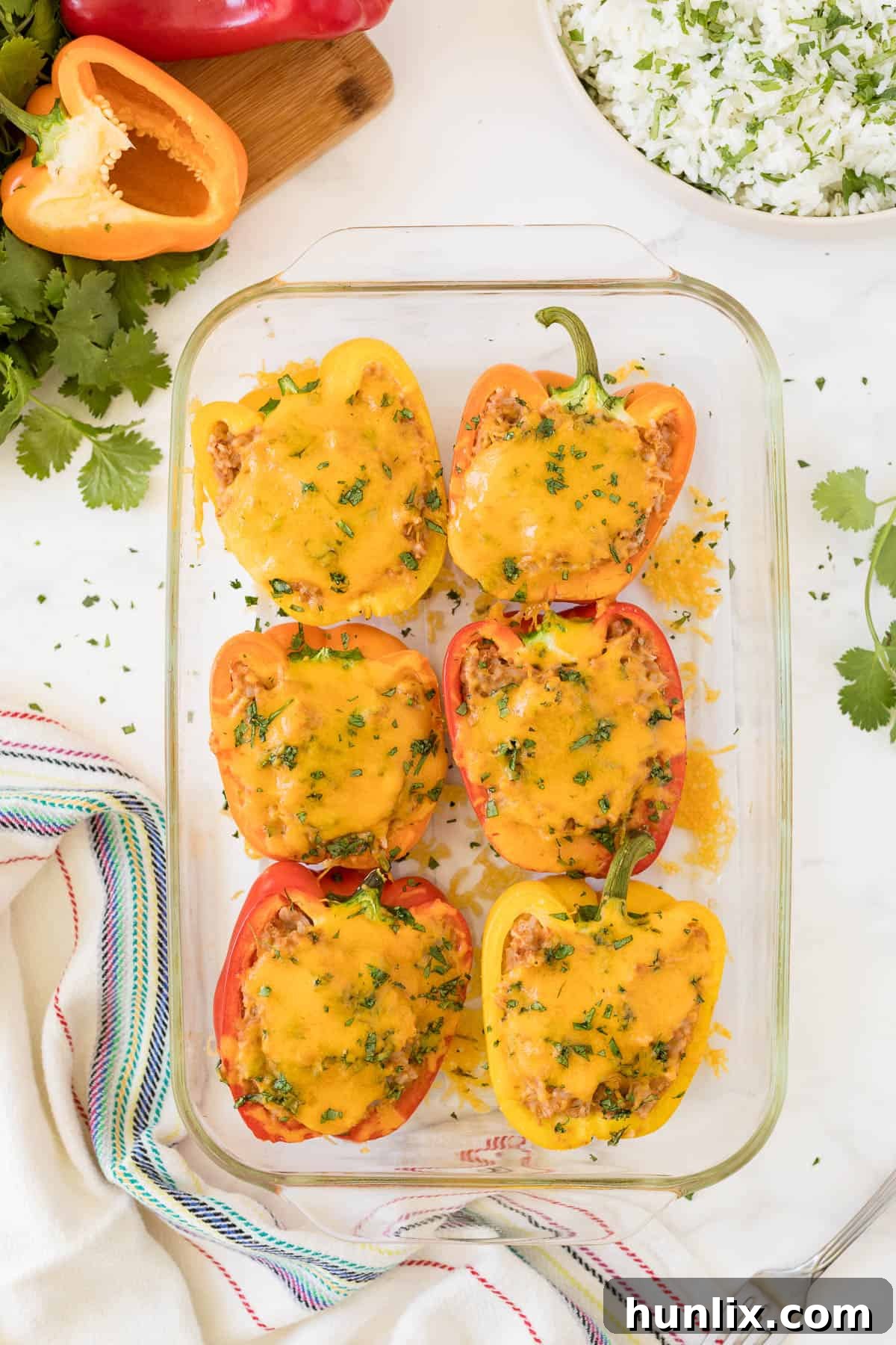 Mexican stuffed peppers in a casserole pan, ready to serve.