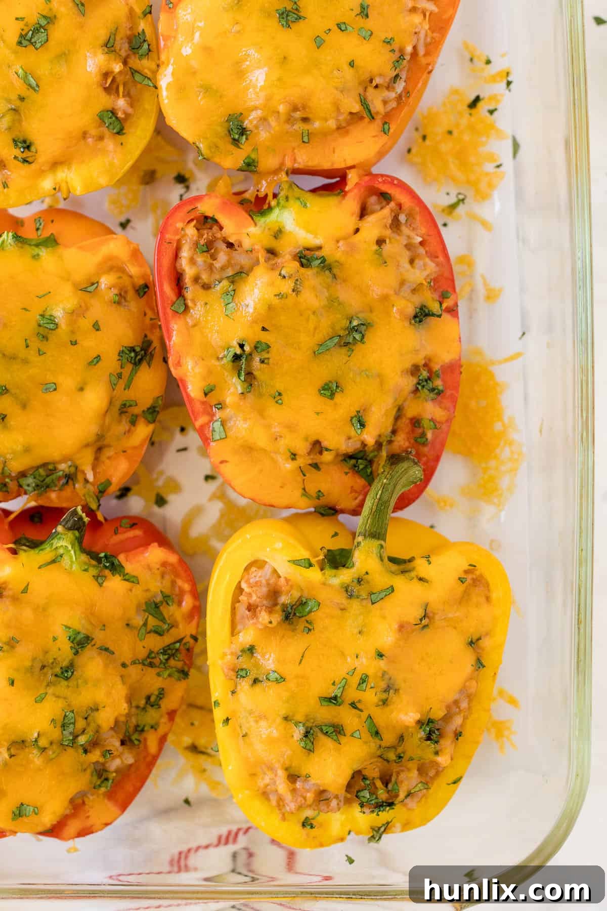 A close-up of the cooked Mexican stuffed peppers in a casserole dish.