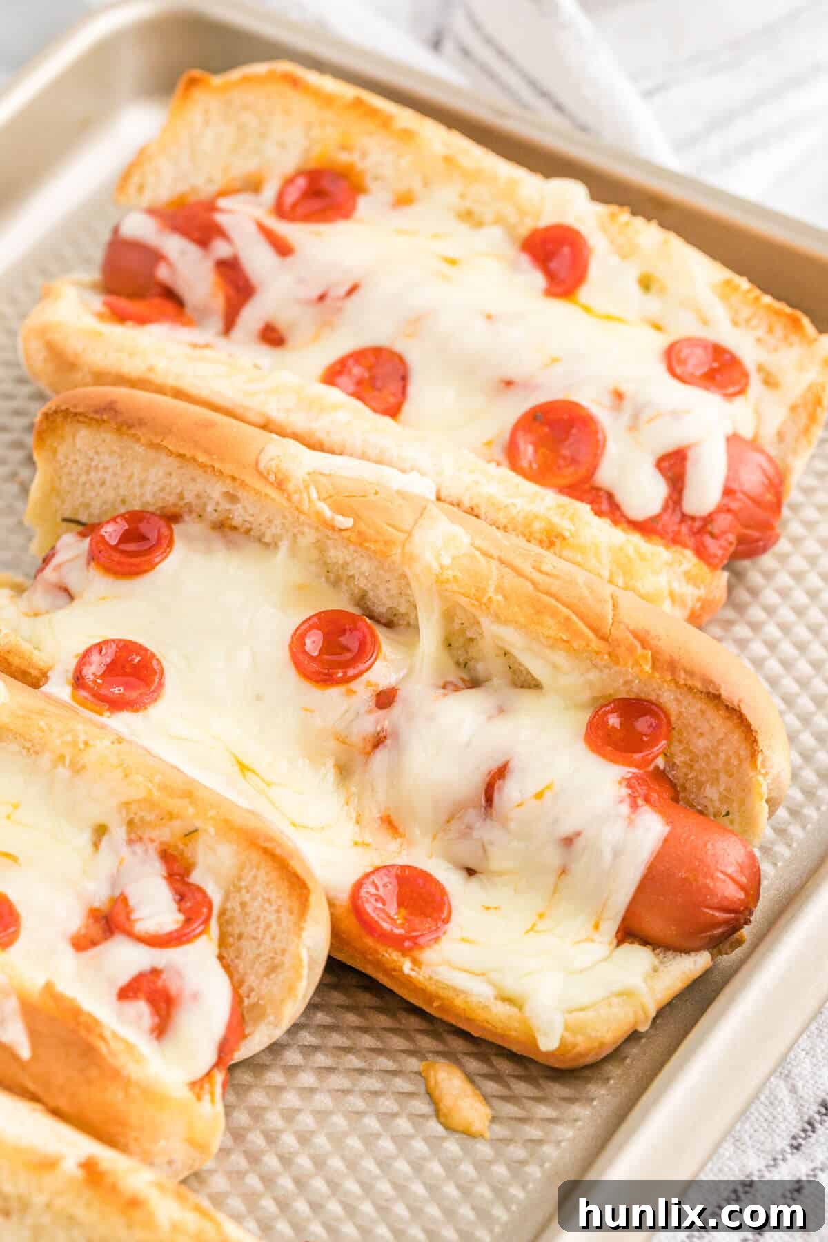 Pizzadog 2 Pizza hot dogs on a baking sheet, ready to be served or baked further.