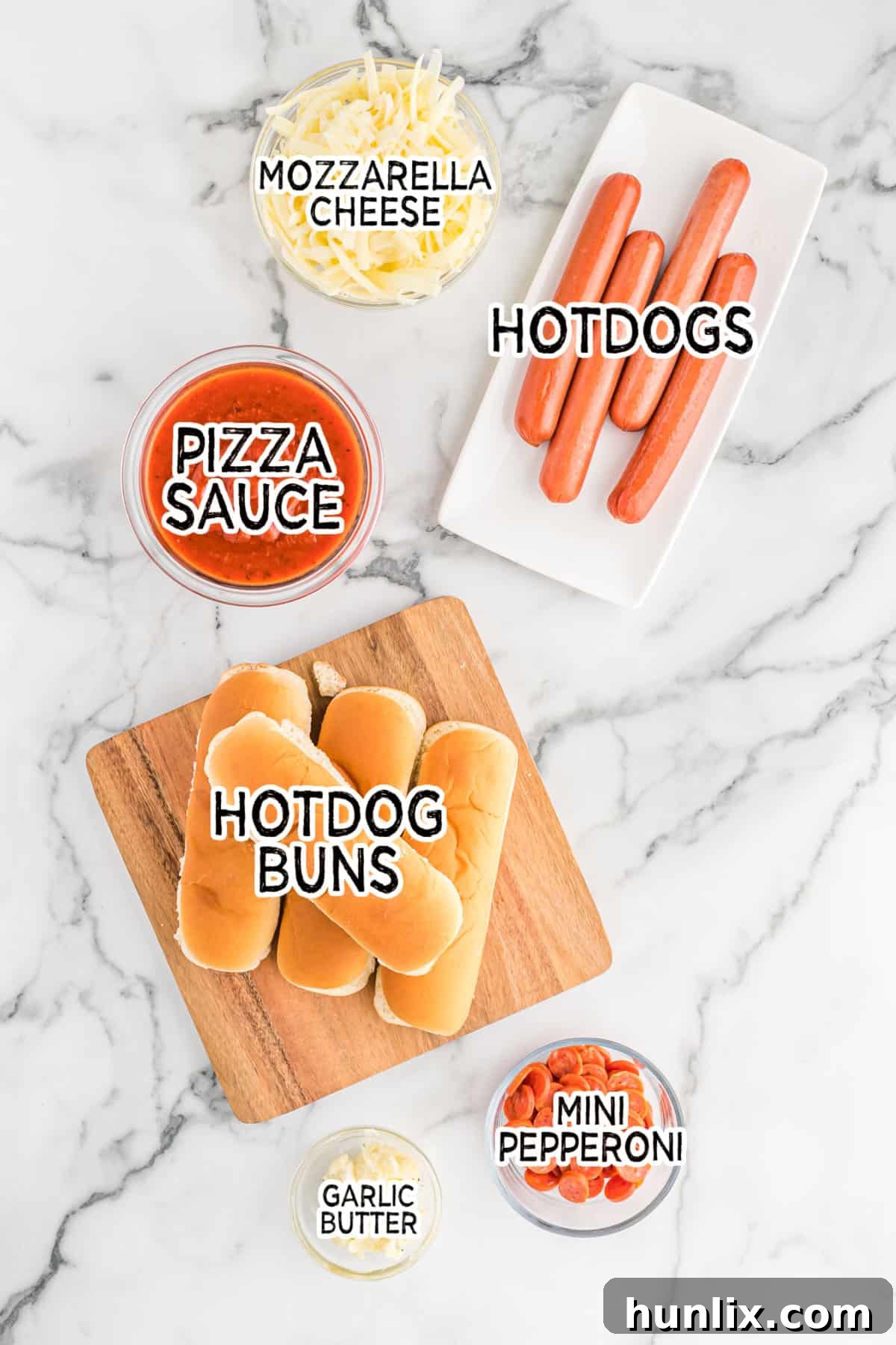 Pizzadog 3 Close-up view of pizza hot dog ingredients laid out on a table.