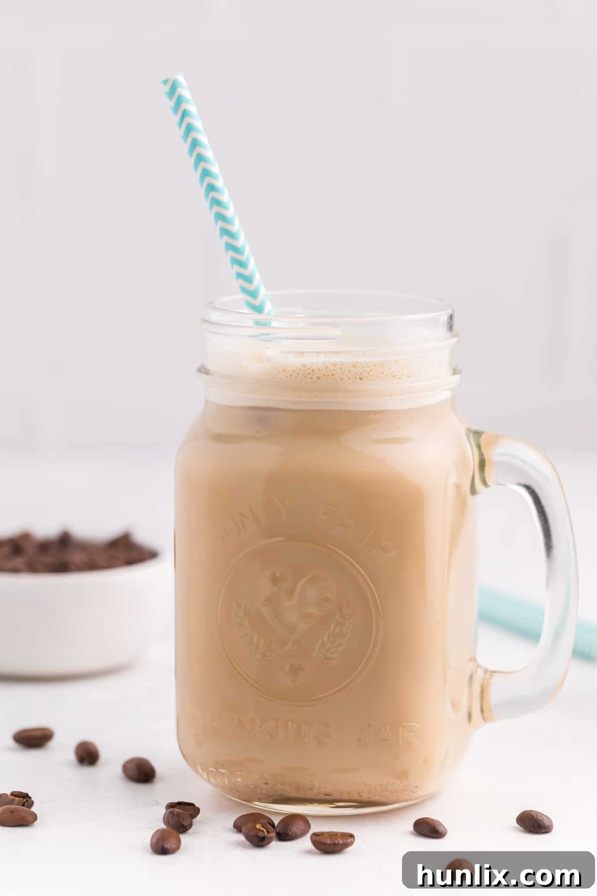 The delicious iced coffee recipe served in a charming jar with a straw, ready to be sipped.