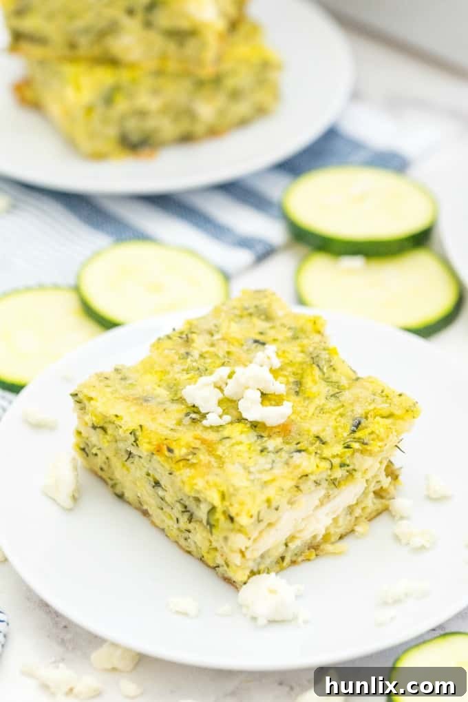 A large rectangular baking dish filled with Cheesy Zucchini Bake, with a golden-brown top, suggesting it's ready to serve a gathering.