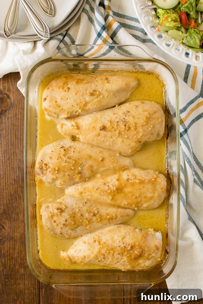 Golden Honey Garlic Chicken 2 Honey Garlic Chicken in a clear baking pan, glistening with sauce.