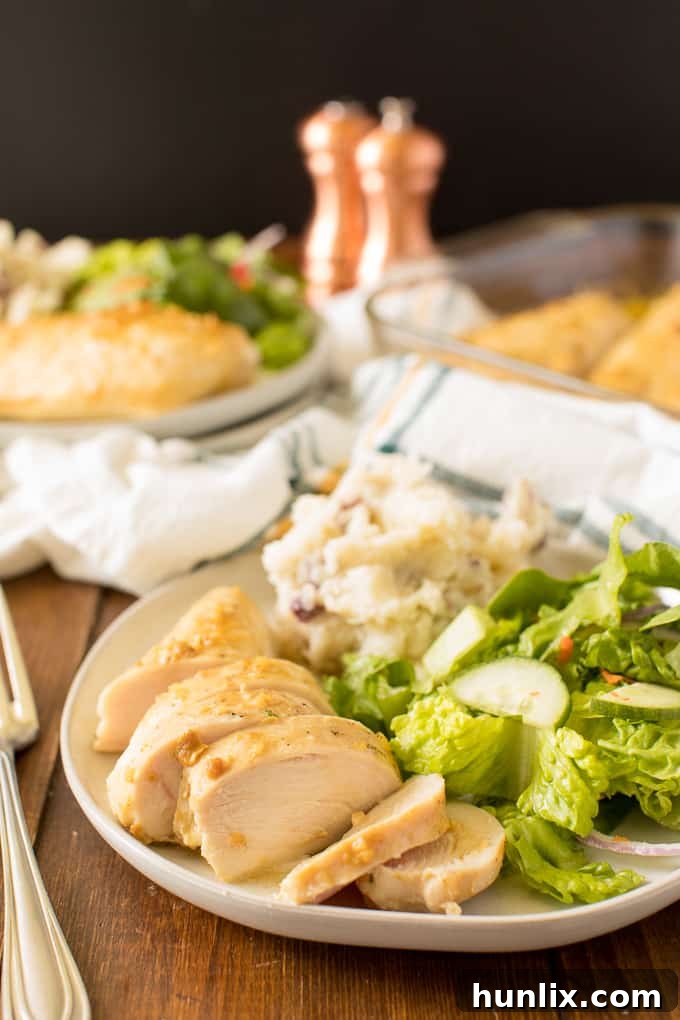 Golden Honey Garlic Chicken 8 A plated serving of Honey Garlic Chicken with a side of mashed potatoes and a fresh green salad.