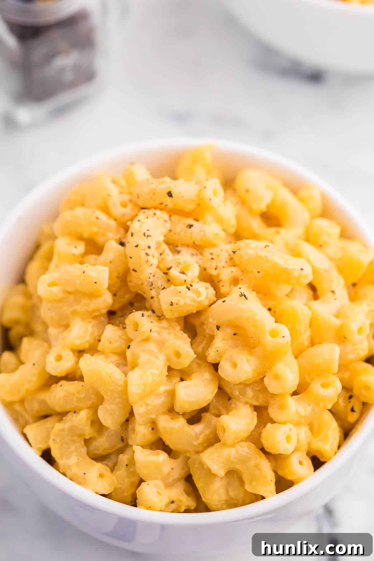 A perfectly portioned bowl of stovetop mac and cheese, ready to eat.