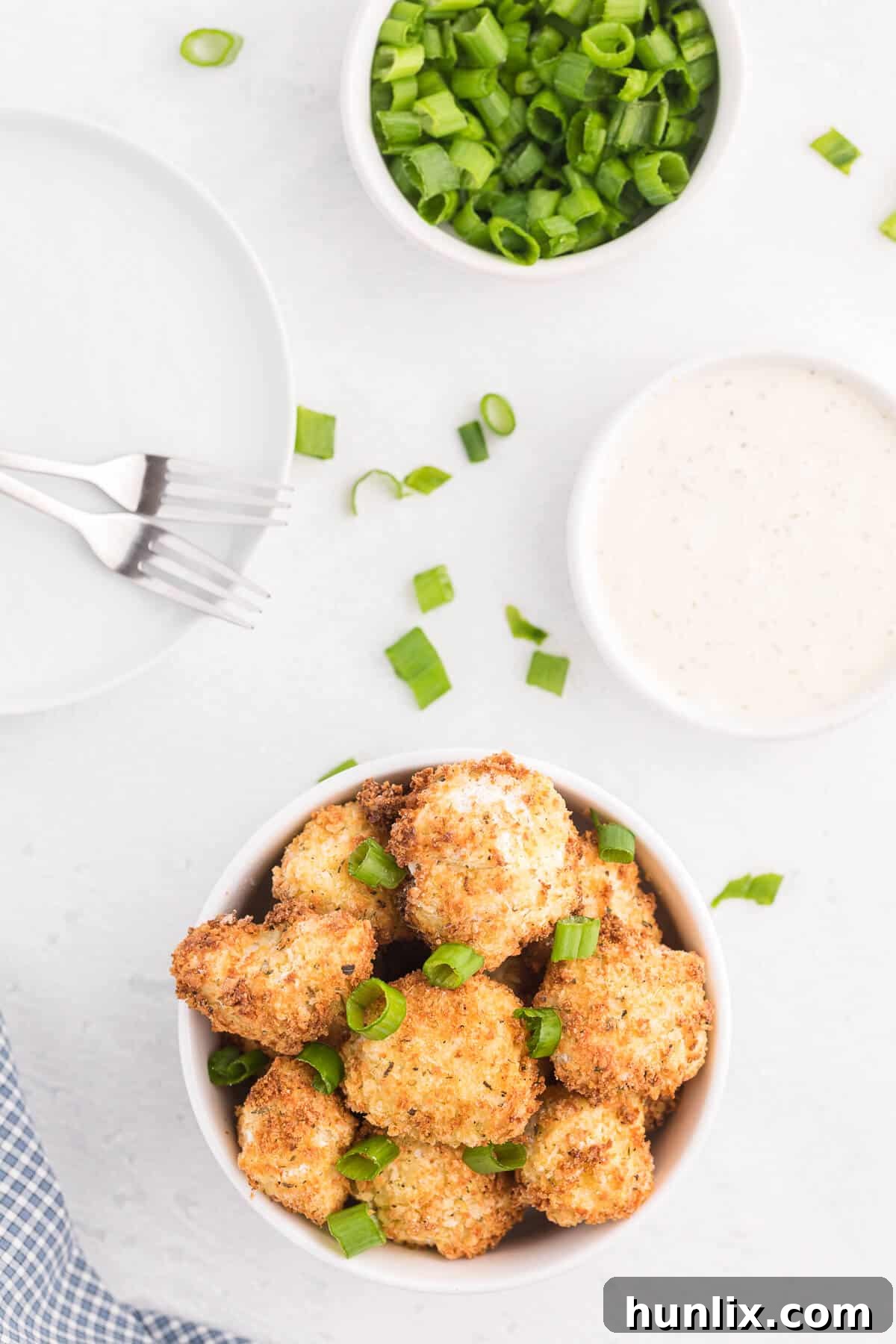 Golden-brown, crispy Air Fryer Cauliflower Bites served in an elegant white bowl, ready for dipping.