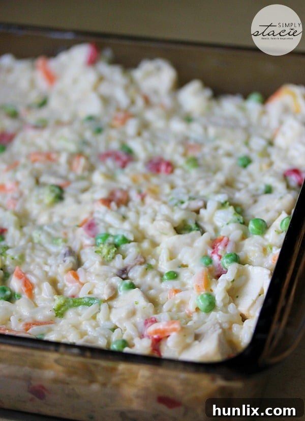 Mixing creamy chicken and rice casserole ingredients