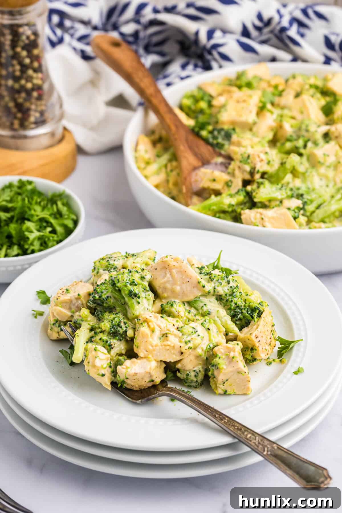 Ultimate Cheesy Chicken Broccoli Bake 7 Cheesy chicken and broccoli on a plate with a fork.
