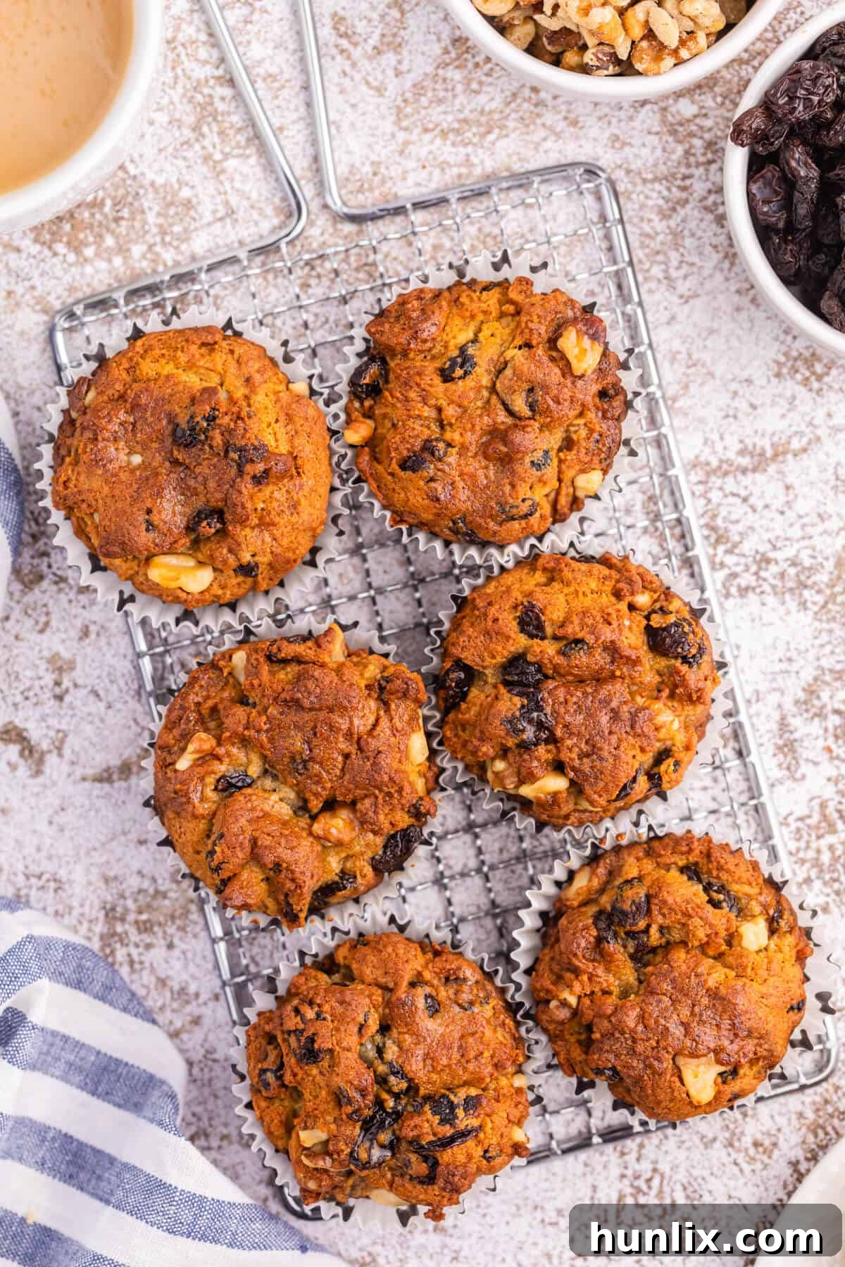 Golden Butter Tart Muffins 2 Freshly baked Butter Tart Muffins cooling on a wire rack, showcasing their golden-brown tops and delicious texture.