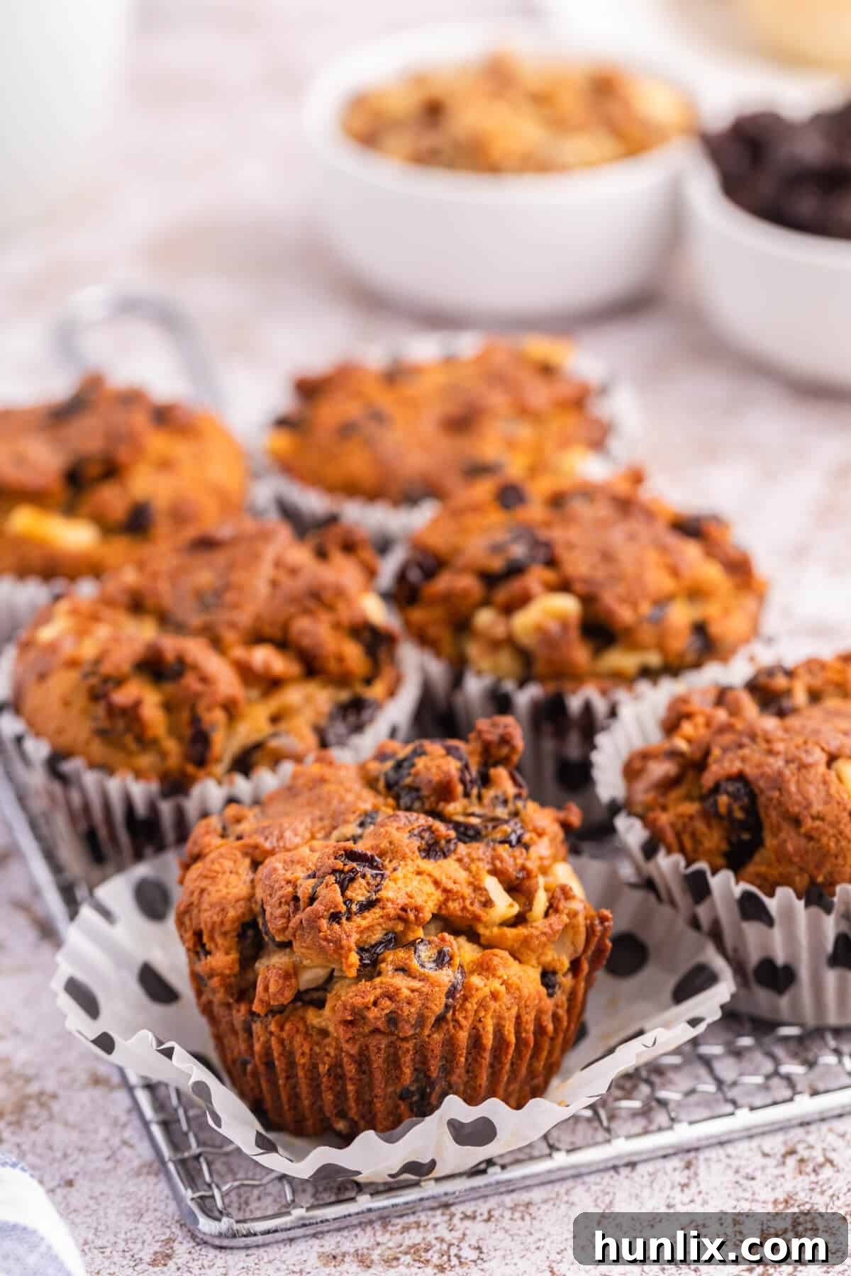 Golden Butter Tart Muffins 3 A close-up shot of Butter Tart Muffins arranged beautifully on a rustic wire cooling rack, highlighting their inviting golden crusts.