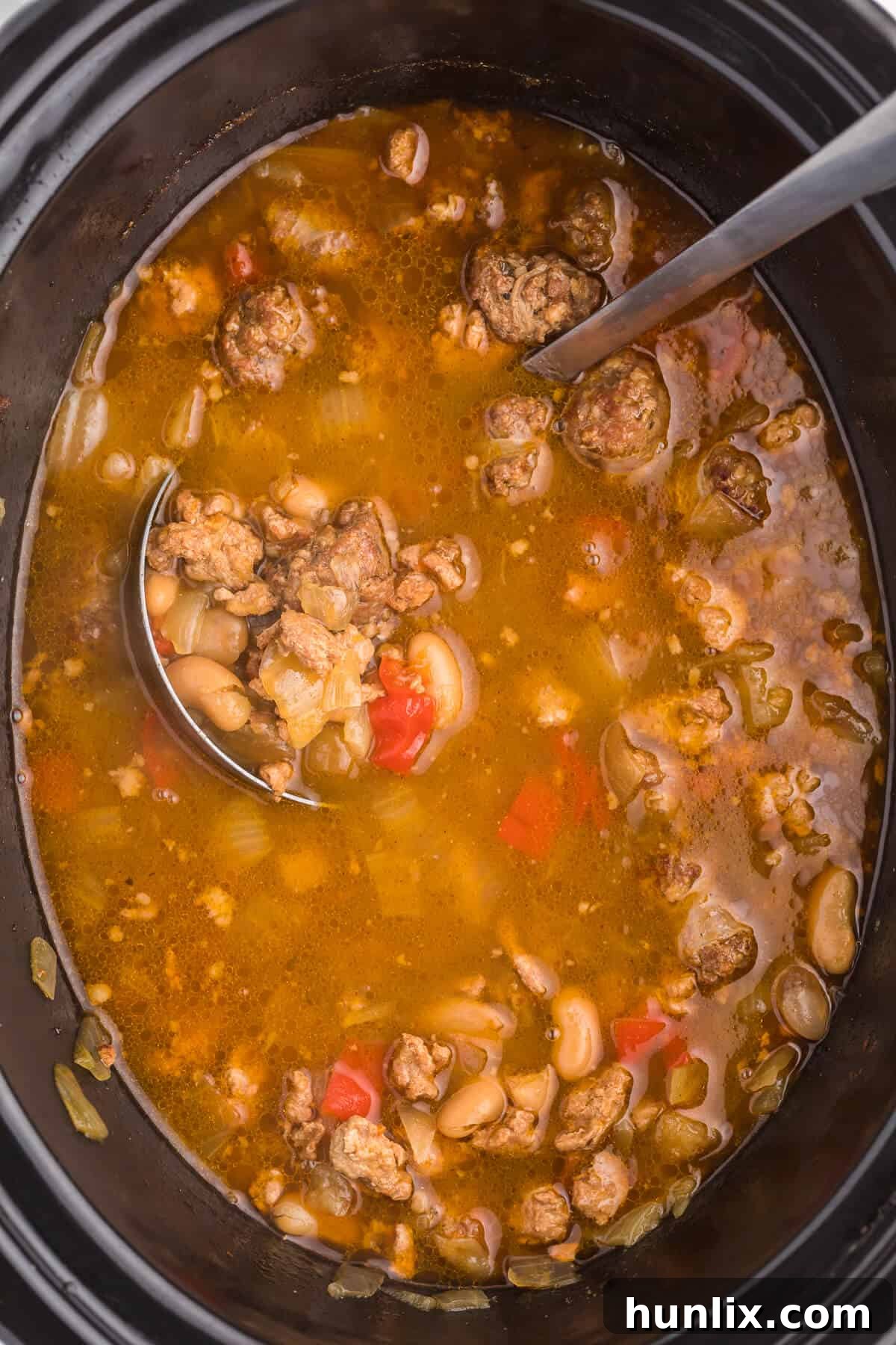 Robust Chicken and Sausage Stew 2 Hearty Slow Cooker Chicken and Sausage Soup with ground chicken, sliced Italian sausage, beans, and vegetables, perfect for a cold day