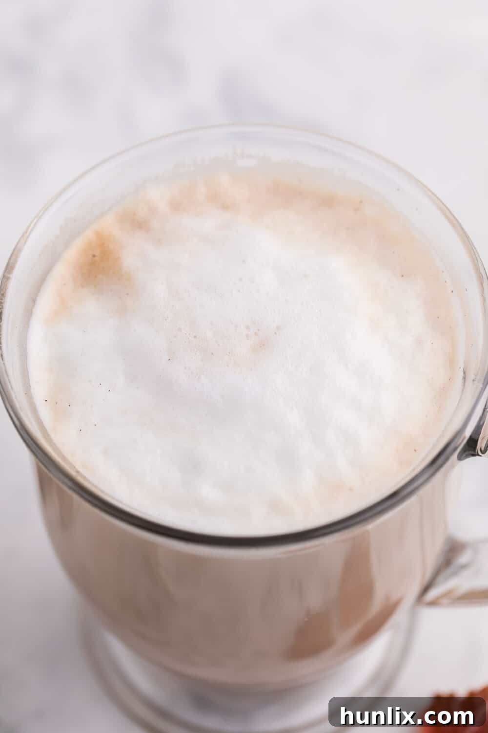 The top view of a maple latte in a mug, showcasing the beautiful foam and a light brown color.
