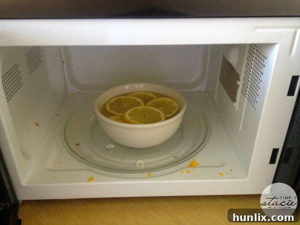 Before Cleaning: A close-up of a dirty microwave interior, showing visible food splatters and grime before the natural cleaning process begins, highlighting the challenge to be addressed.