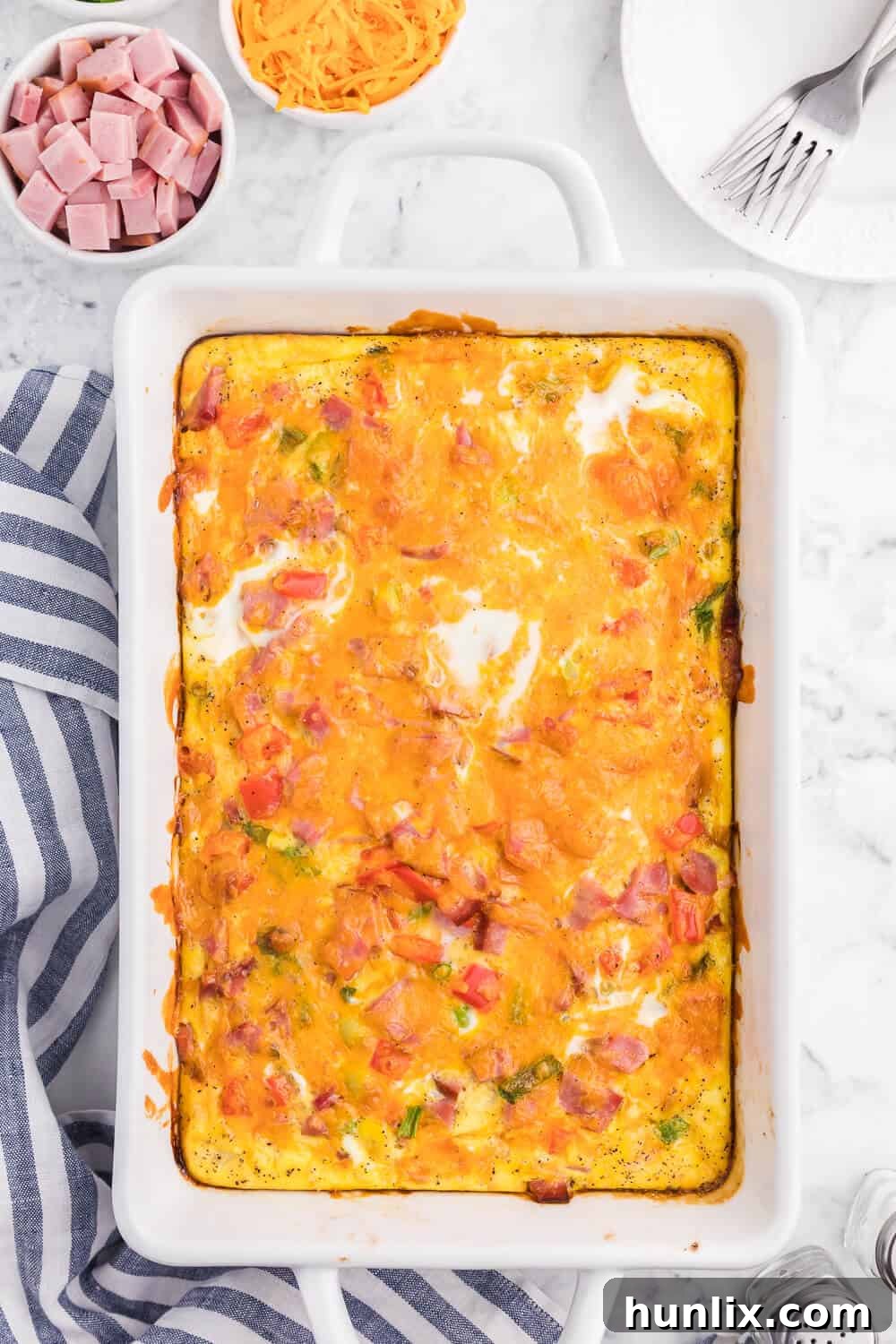 Golden Hash Brown Quiche 2 Hash brown quiche in a white casserole dish.