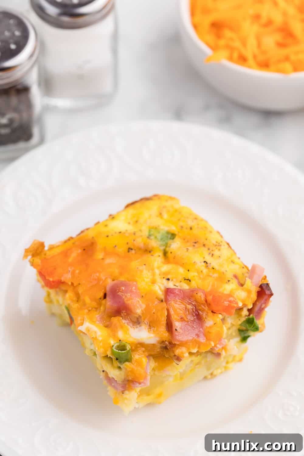 Golden Hash Brown Quiche 6 A slice of the recipe on a plate.