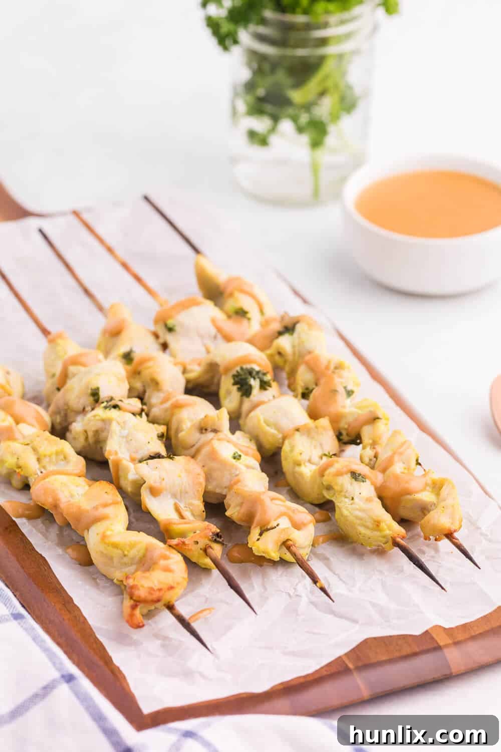 Flavorful Chicken Satay with Creamy Peanut Sauce - An easy, healthy appetizer or main dish made with simple ingredients. Perfect for broiling in the oven!