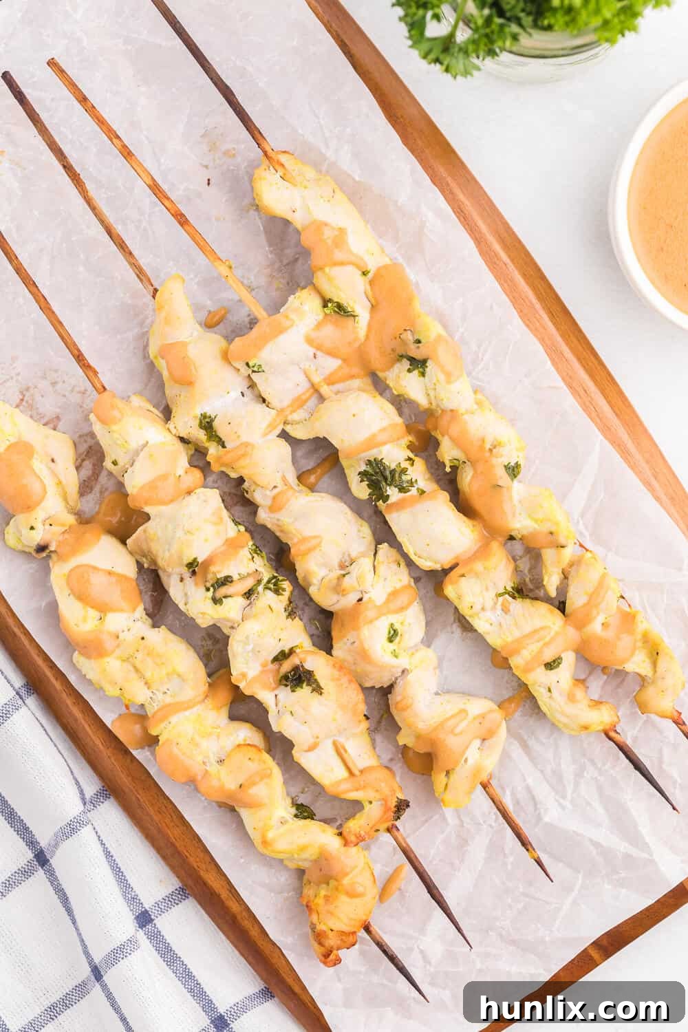 Easy Chicken Satay Skewers with Homemade Peanut Dipping Sauce - A crowd-pleasing, healthy appetizer cooked in the oven.