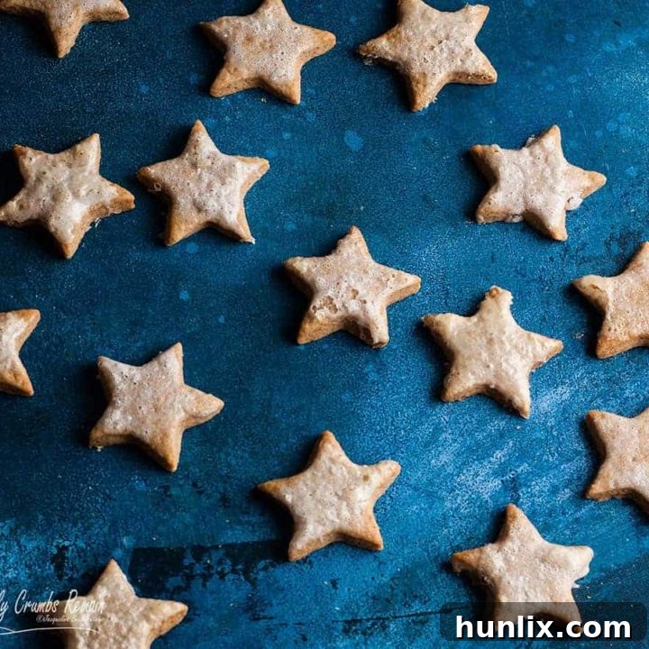Crisp cinnamon star cookies with a crunchy meringue icing, a festive Christmas delight.