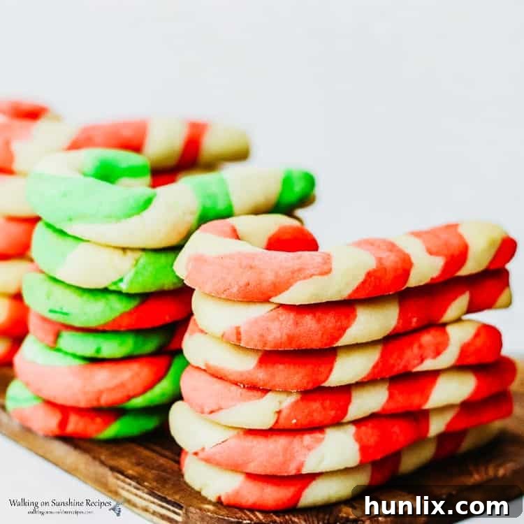 Colorful candy cane sugar cookies, twisted into a festive shape, a Christmas essential.