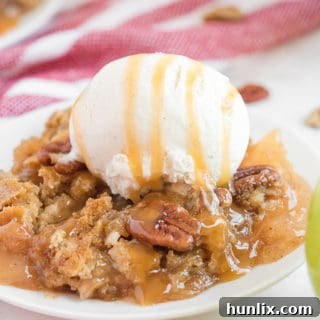 Effortless Caramel Apple Delight 10 A plate of caramel apple dump cake and vanilla ice cream, showing the warm, golden-brown crust and melted ice cream.