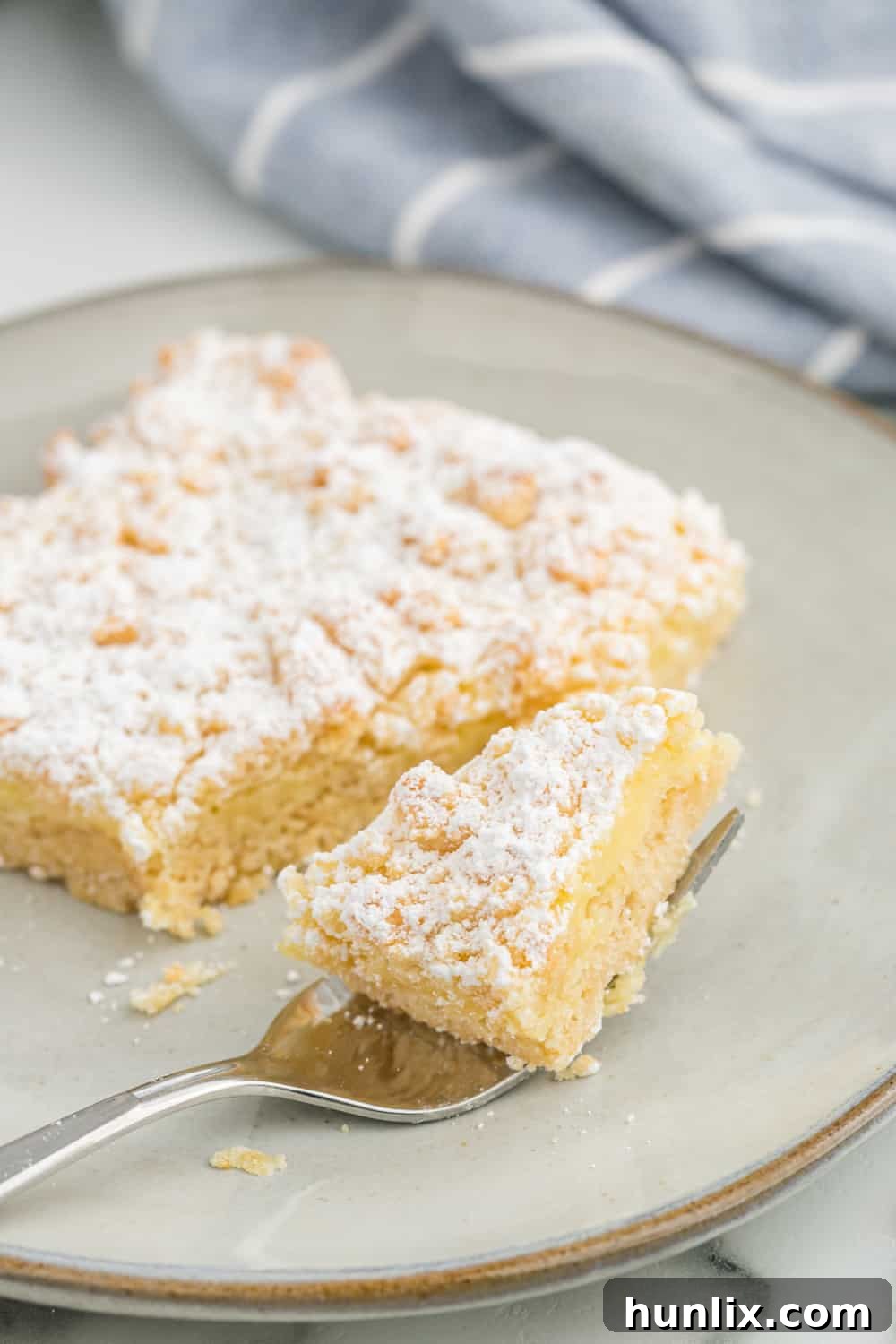 A bar on plate with a bite on a fork.