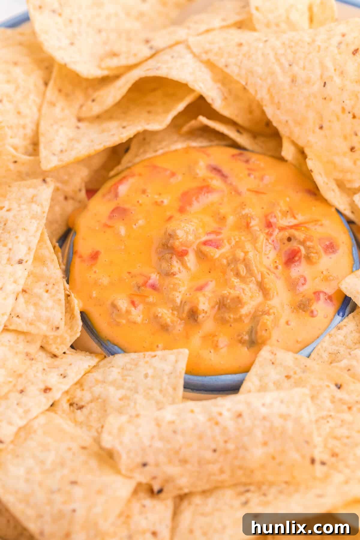 Ultimate Chicken Queso 4 Delicious Chicken Queso Dip in a white bowl, ready to be served.