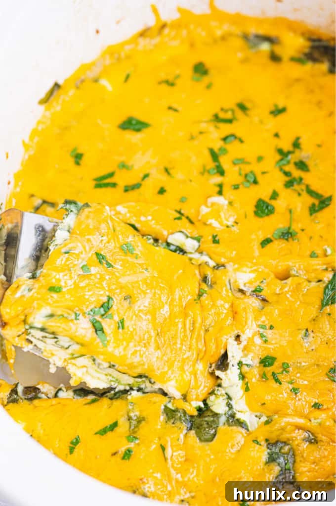Close-up of baked Slow Cooker Spinach & Feta Quiche, showcasing its golden-brown top and fluffy texture, ready to be served for a delightful meal.