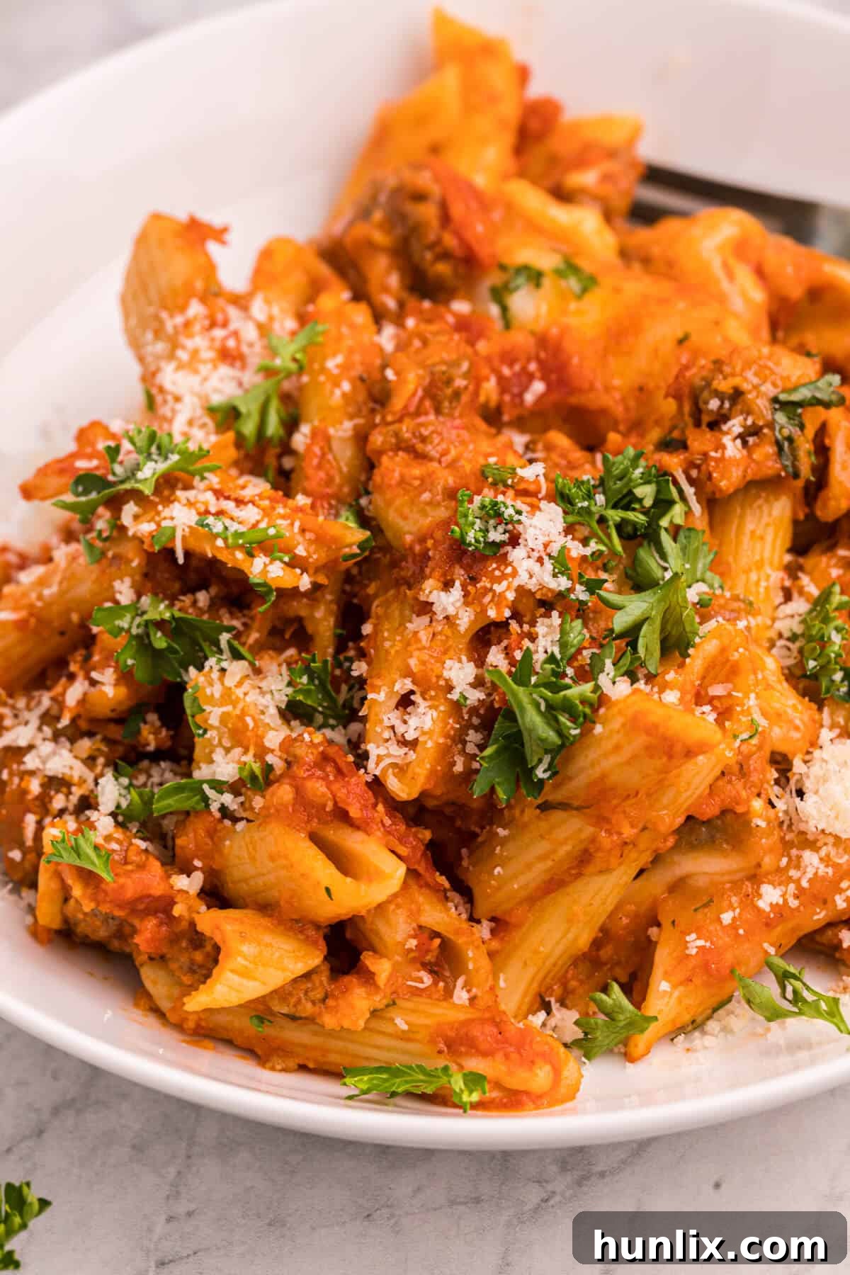 A large serving bowl filled with Slow Cooker Pizza Pasta, ready to be enjoyed by the family.