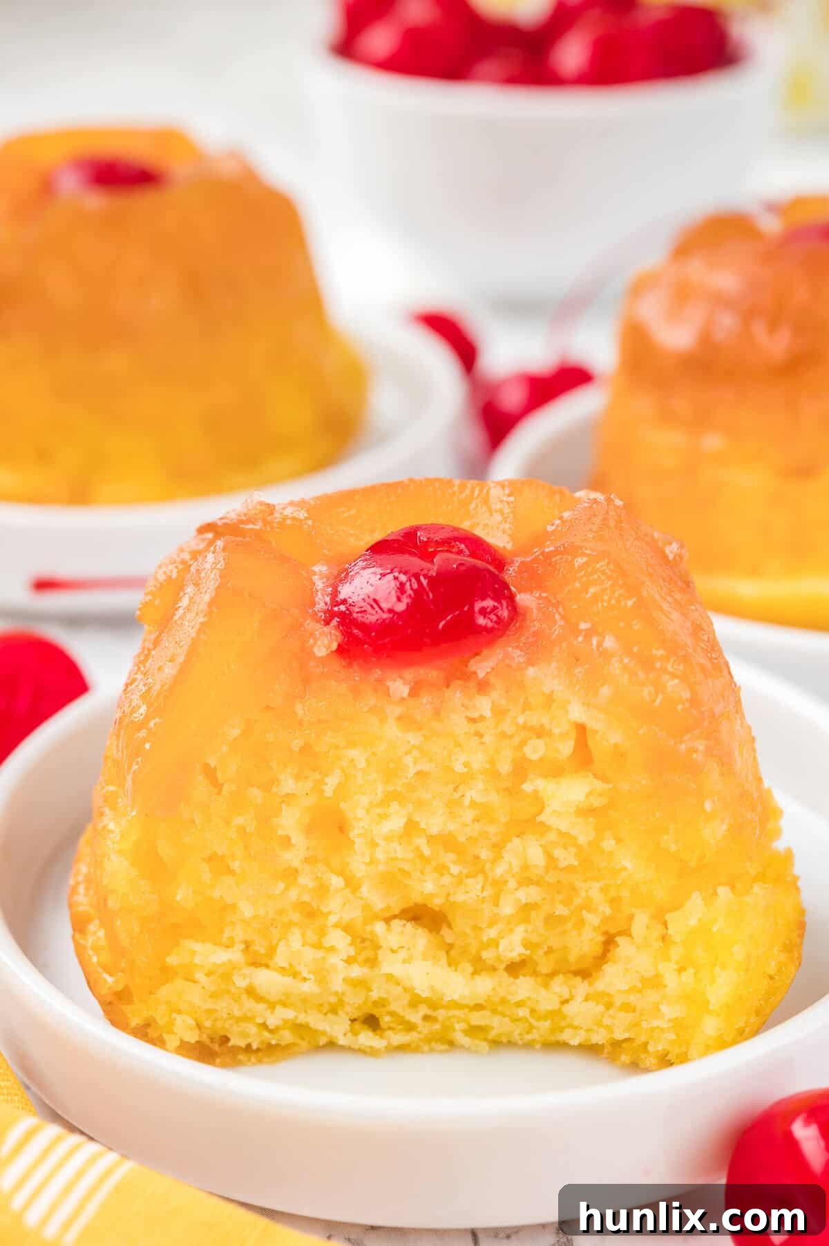 A cupcake cut in half on a plate.