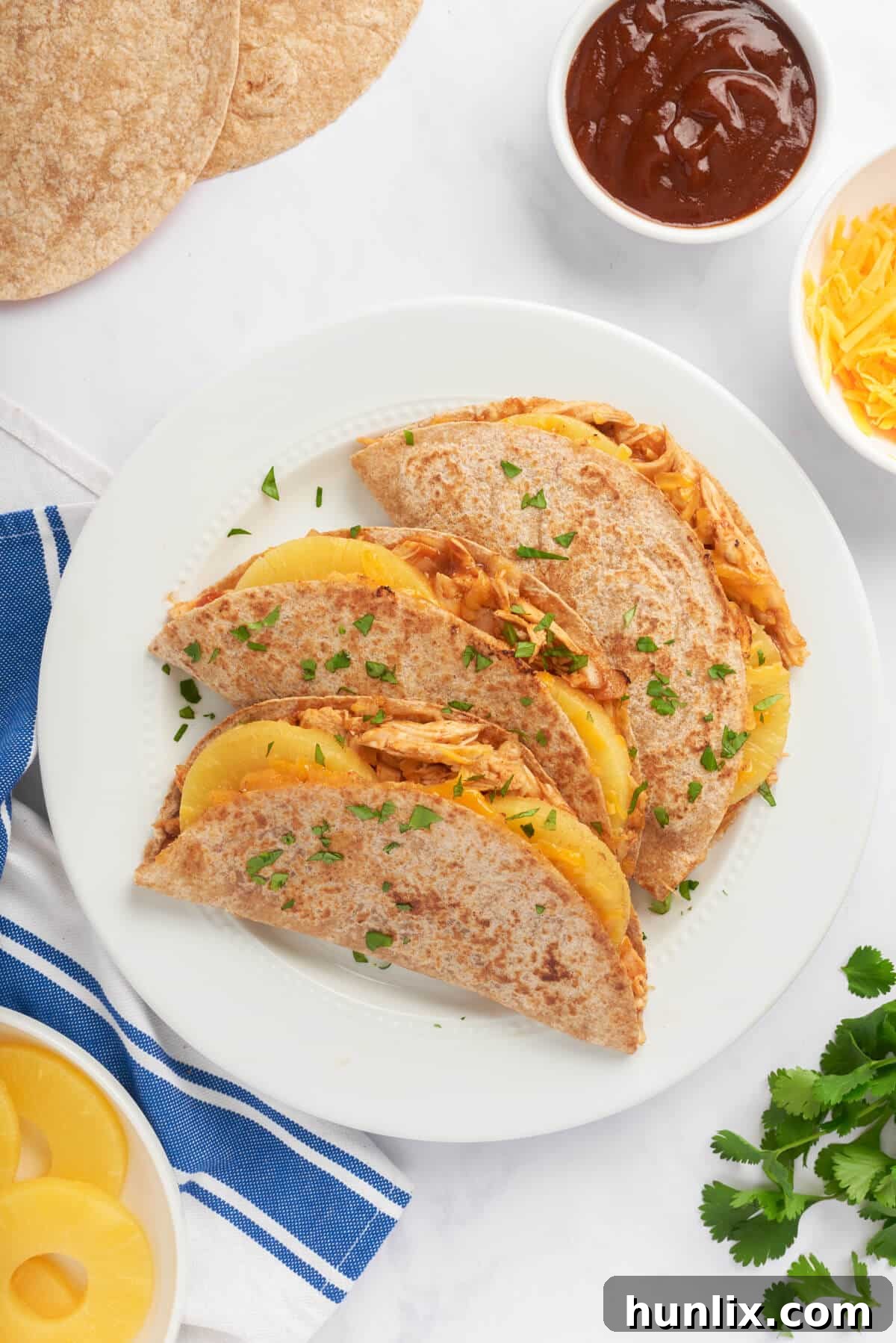 Crispy BBQ Chicken and Pineapple Quesadillas, golden brown and filled with savory chicken, sweet pineapple, and melted cheese, served on a plate.
