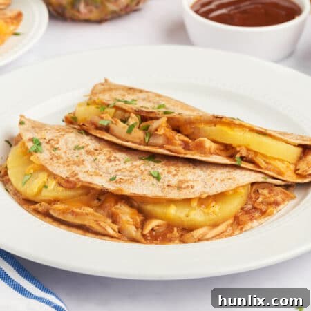 BBQ chicken and pineapple quesadillas on a plate.