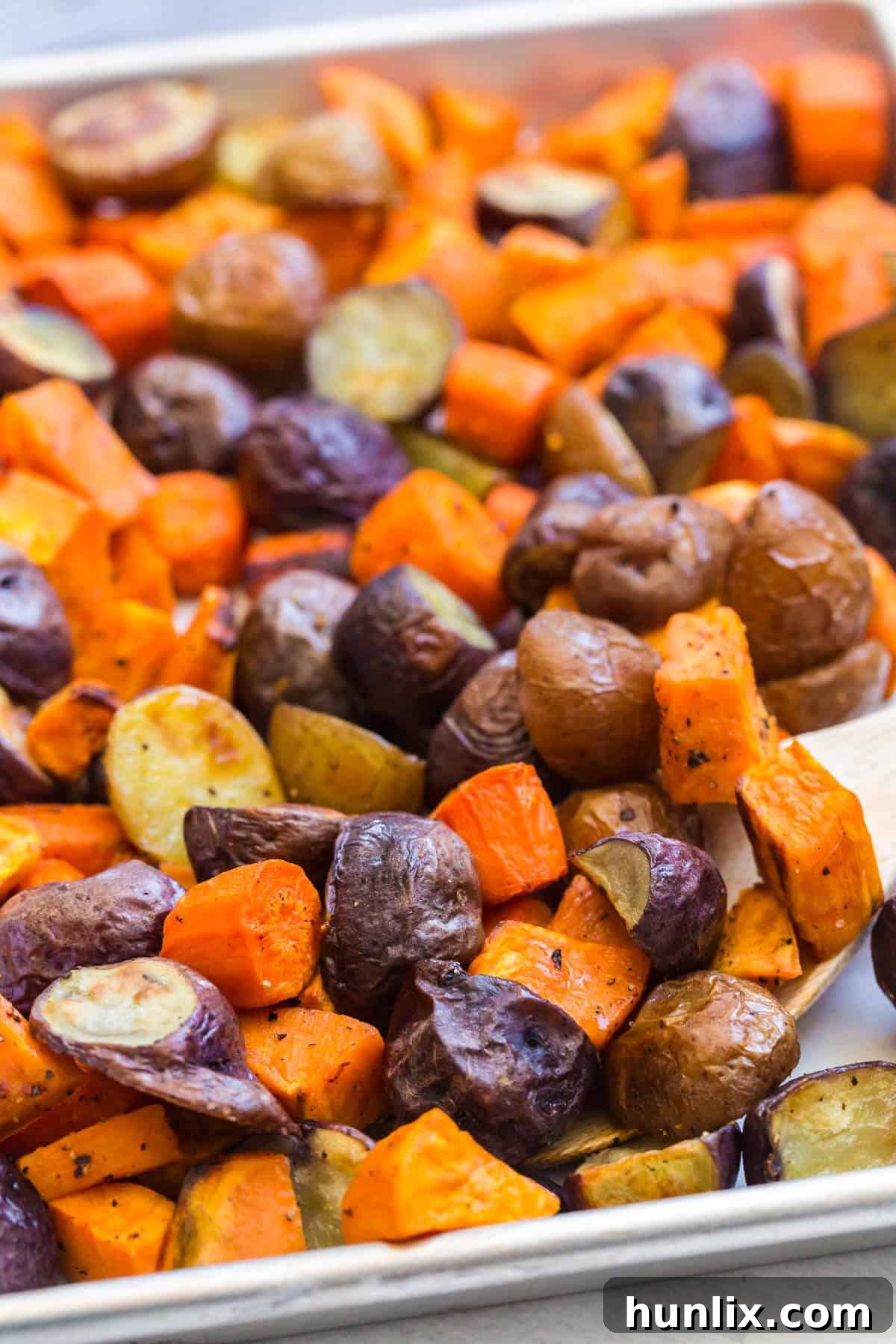 Roasted root vegetables on a sheet pan.