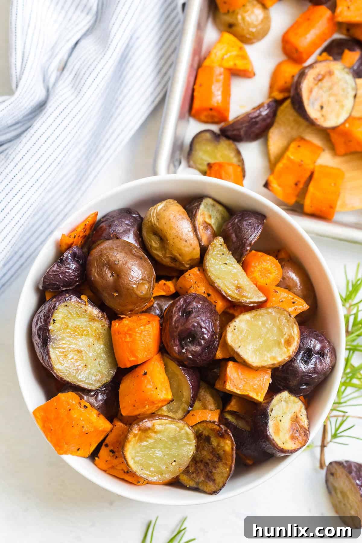 Roasted root vegetables in a white bowl.