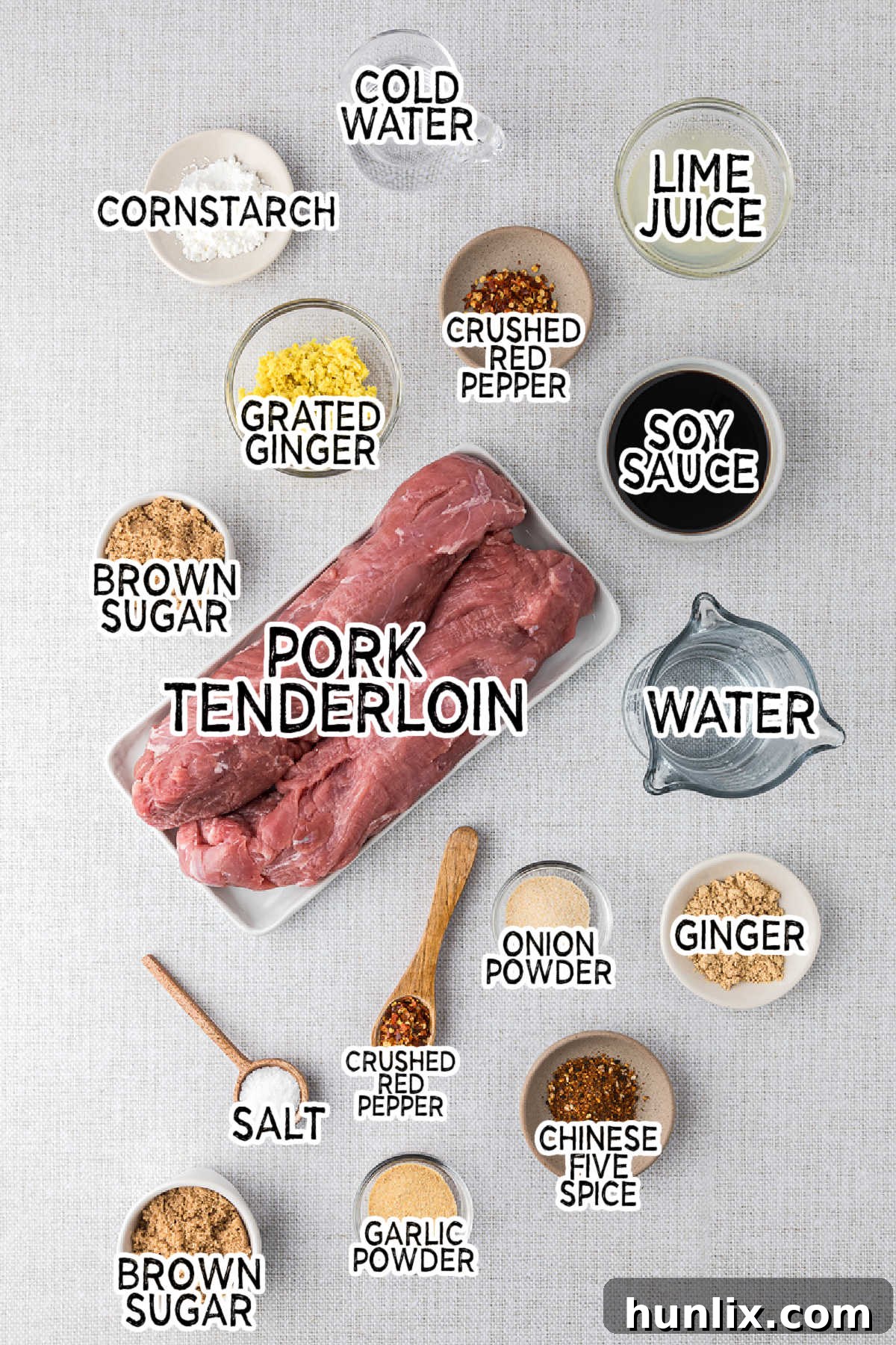 Soy Ginger Pork Tenderloin 3 A collection of Asian pork tenderloin ingredients laid out on a grey surface.