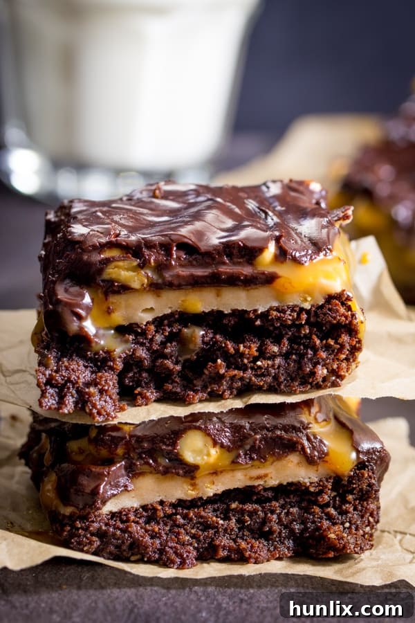 Decadent Snickers Stuffed Brownies 2 Snickers Brownies - Delicious AND gluten free! This decadent dessert recipe is a chocolate lover's dream with layers of nougat, peanuts, and caramel over a rich, moist brownie.